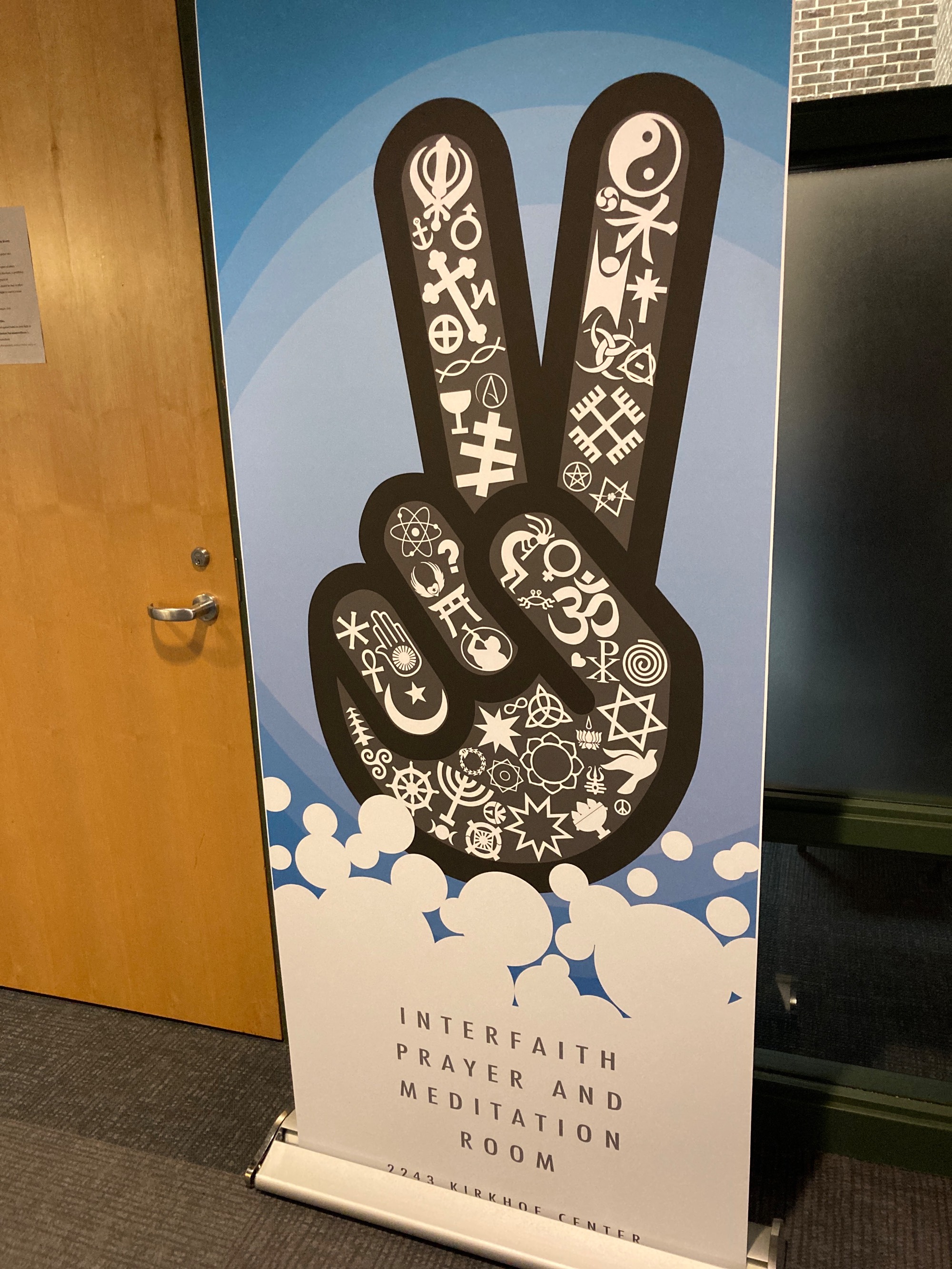 Peace sign banner with various religious symbols